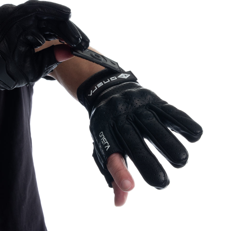 Putting on the black ONSRA RACE e-skate glove, wrist strap detail