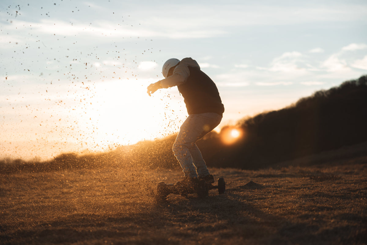 Rider on an ONSRA VELAR off-road at sunset